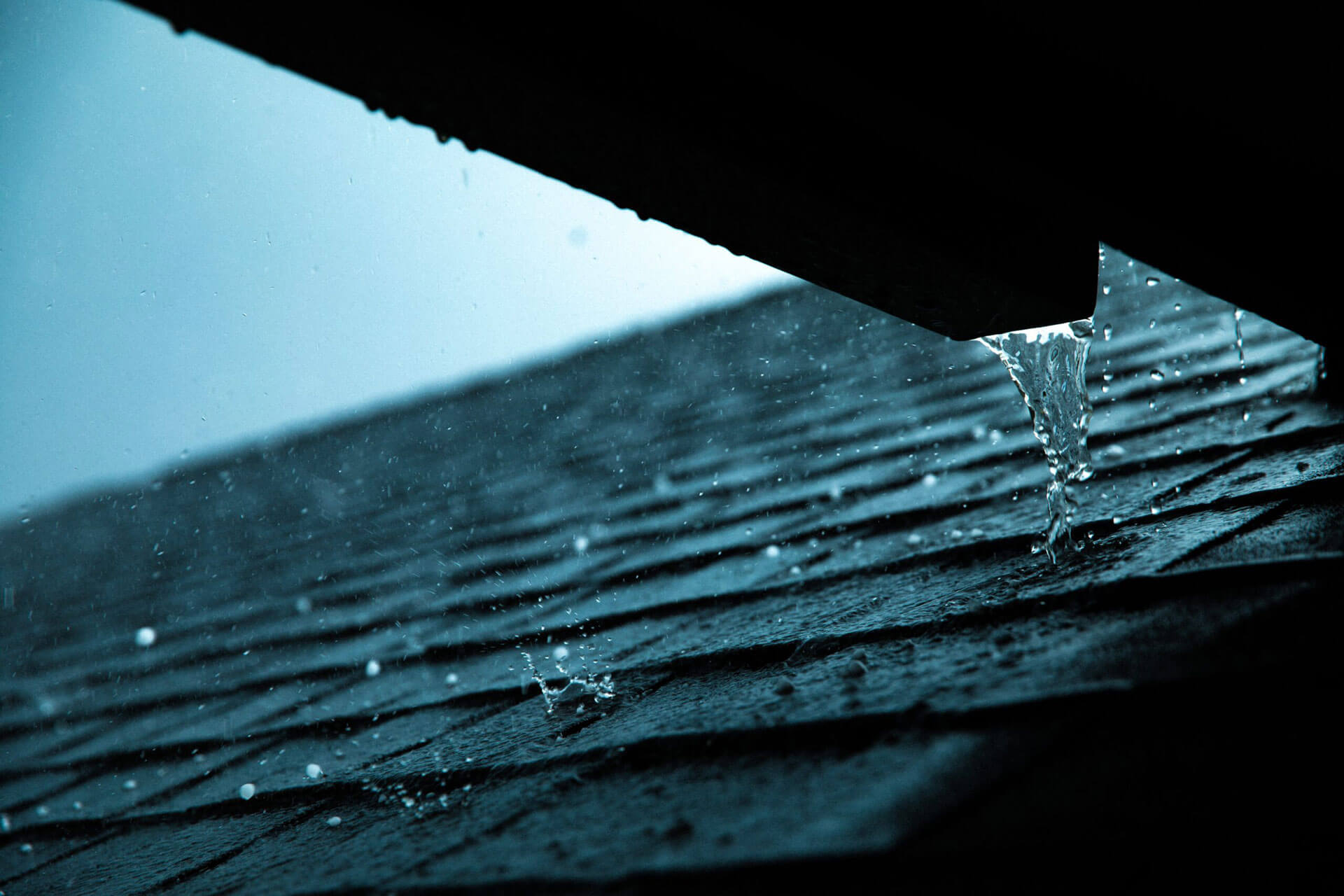 home exterior gutters during rain storm